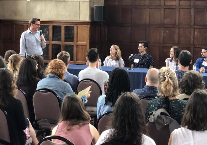 Program Director Glenn Cummings leads a panel of previous students at the Postbac orientation.